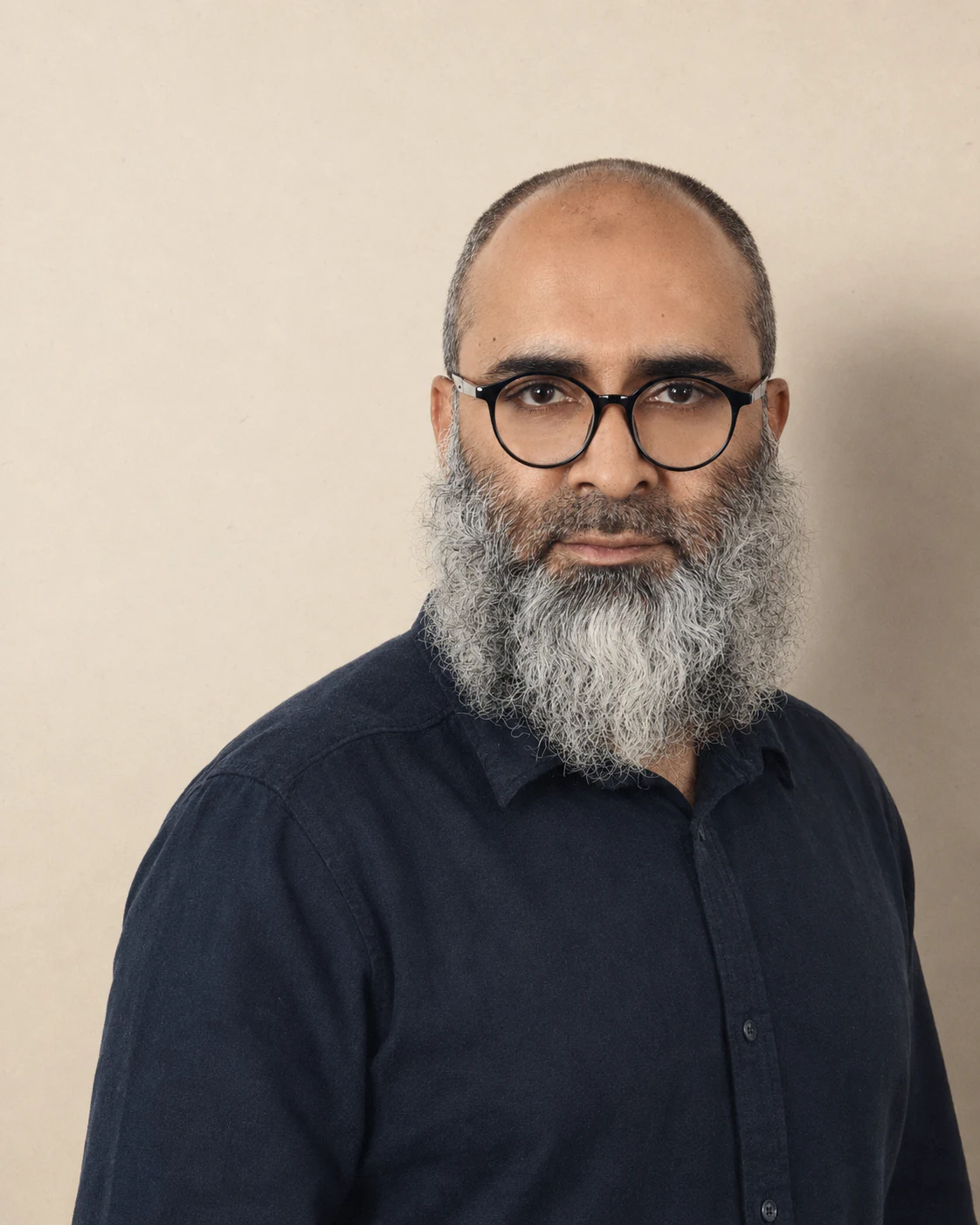 Abdullah Al Mamun, founder of Creativity Sequence, photographed against a bone paper backdrop in the Riyadh studio