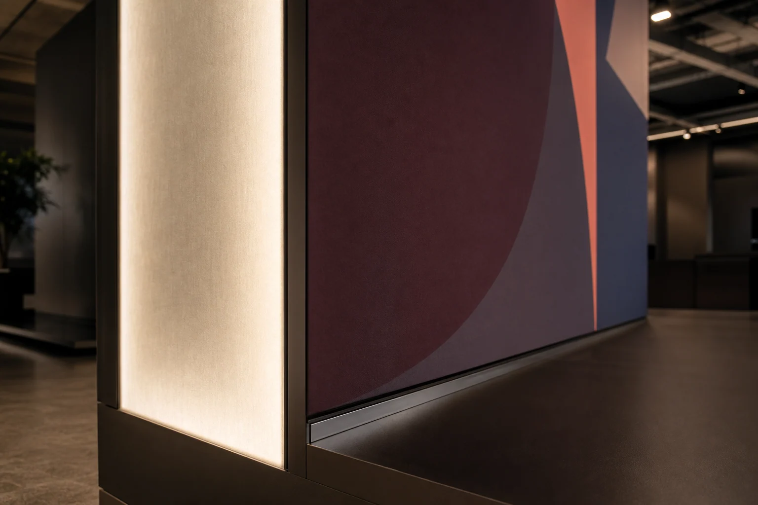 Close view of exhibition booth graphics, illuminated structure and fitted counter