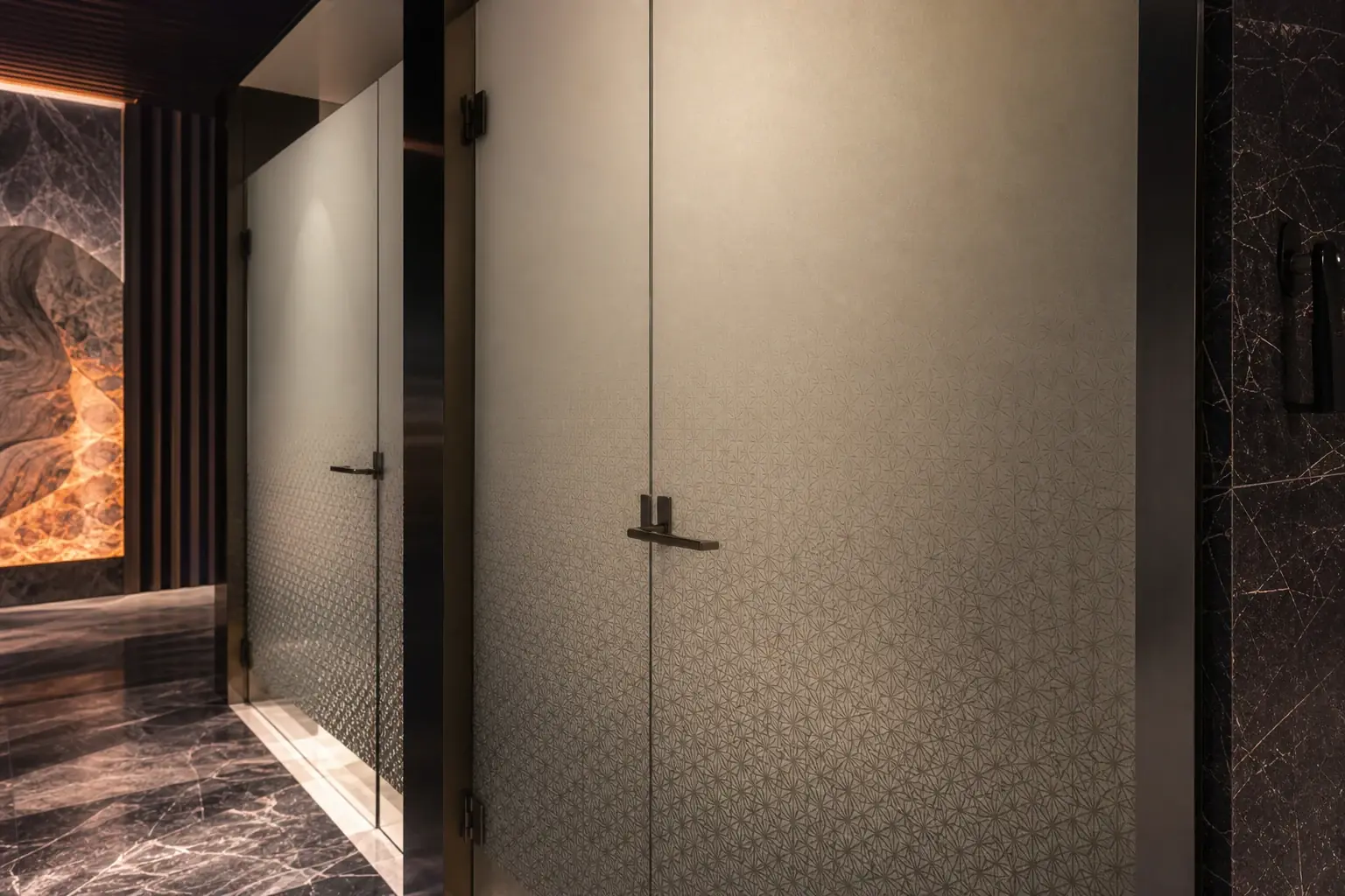 Commercial restroom glass partition with refined frosted privacy graphics